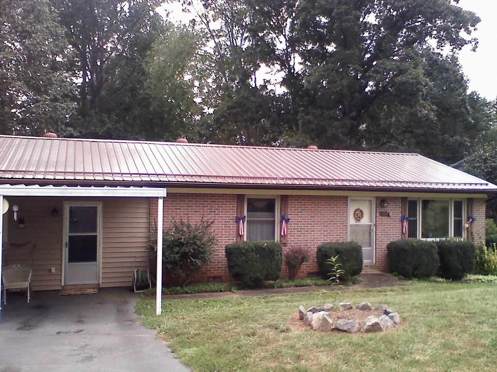 Bronze metal roof and carport on a brick ranch home — Roof Repair work by our crew in South Saint Paul